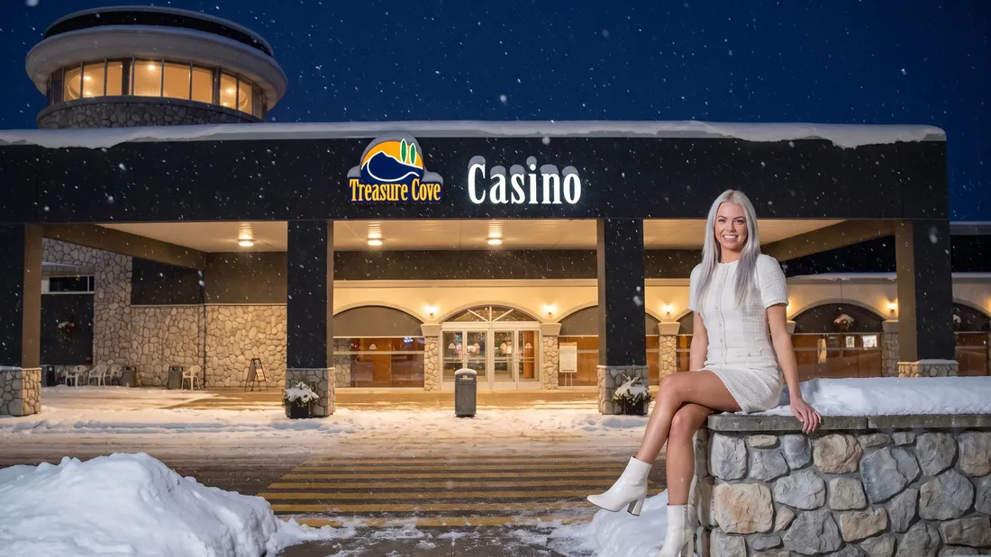 Woman by the Treasure Cove Casino entrance on a snowy night