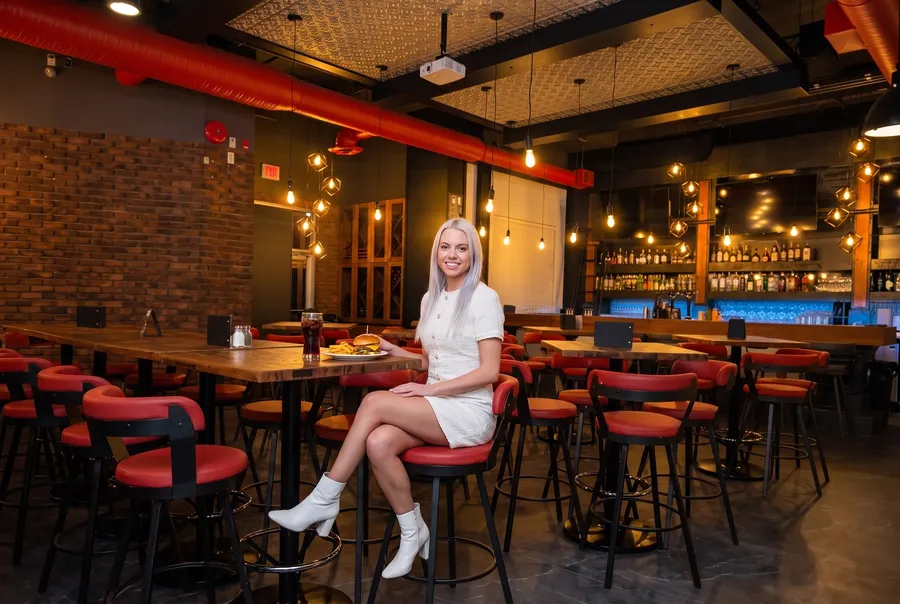 Woman at a high table in BRIXX Brewhouse